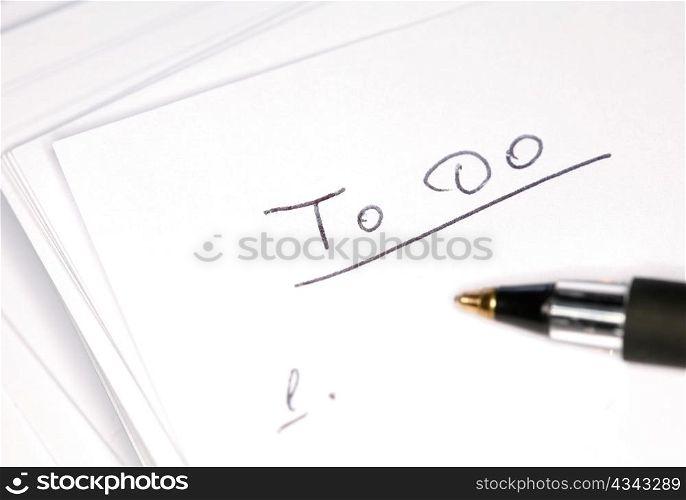 Closeup image of black pen on notebook