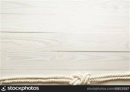 Closeup image of sea knot on white wooden background