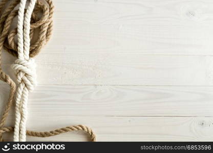 Closeup image of ship ropes on white wooden background