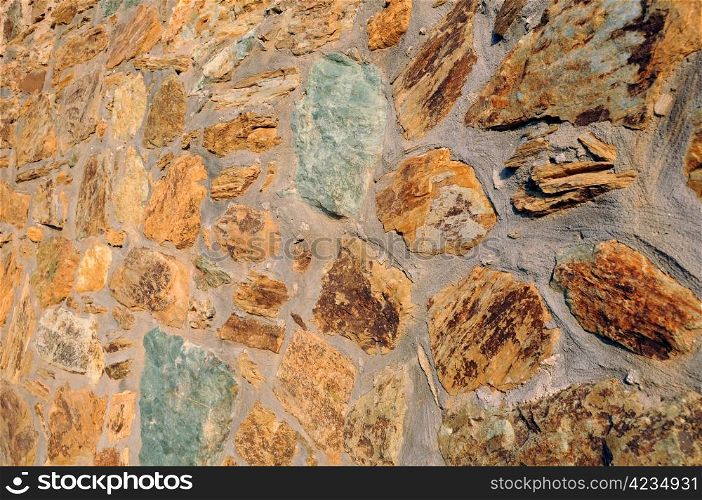 Closeup image of the wall made of natural rocks in Crete island in Greece