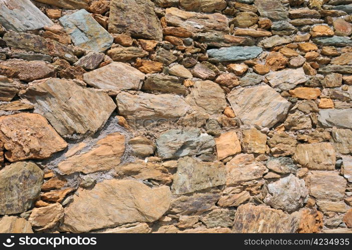 Closeup image of the wall made of natural rocks in Crete island in Greece