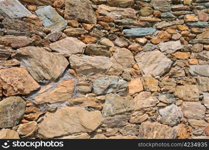 Closeup image of the wall made of natural rocks in Crete island in Greece