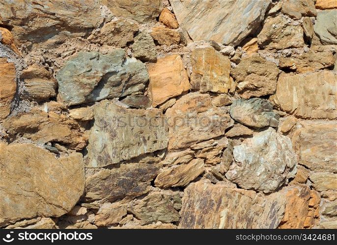 Closeup image of the wall made of natural rocks on Crete island in Greece