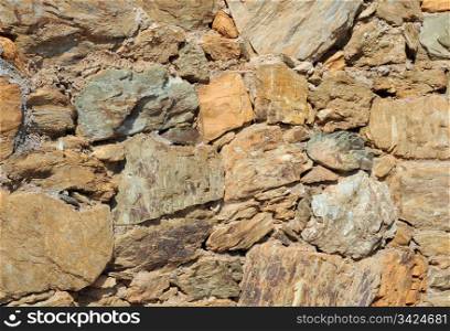 Closeup image of the wall made of natural rocks on Crete island in Greece