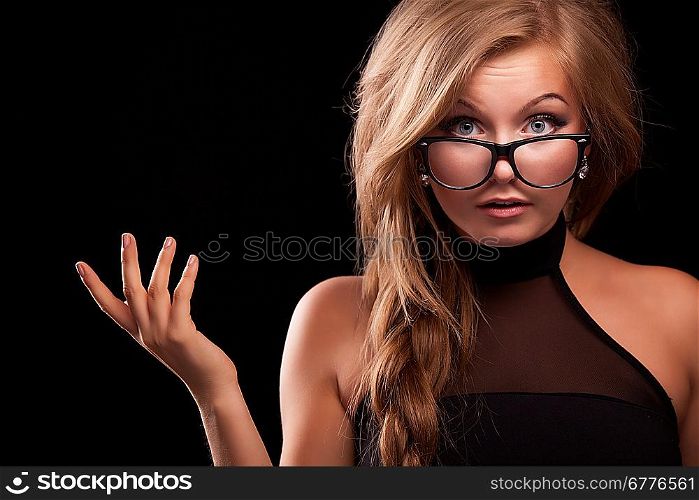 closeup indignat woman in black glasses on black background