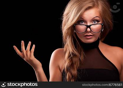 closeup indignat woman in black glasses on black background