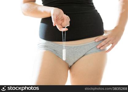 Closeup isolated photo of young woman holding sanitary tampon
