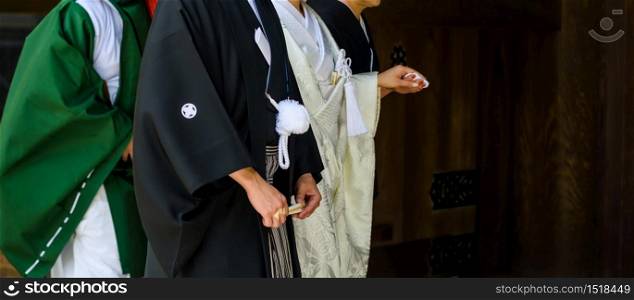 Closeup Japanese bride and groom with traditional costume Celebrate of Shinto wedding at Meiji Jingu Shrine in Tokyo, Japan.