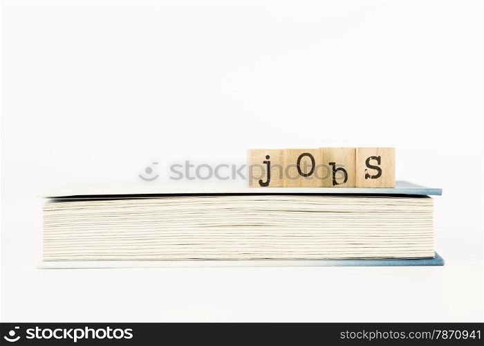 closeup jobs wording on a book, employment and business concepts and ideas
