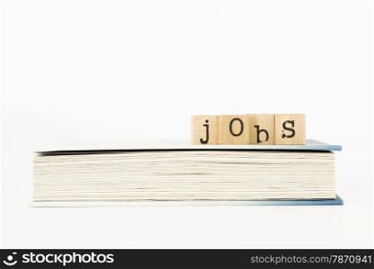 closeup jobs wording on a book, employment and business concepts and ideas
