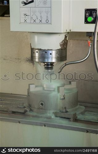 closeup lathe machine and coolant during processing. lathe and workshop equipment