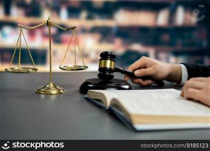 Closeup lawyer or attorney preparing for lawsuit or litigation, reading or studying on legal book on his desk at library for educational law school concept, decorated with legal symbols. Equilibrium. Closeup lawyer reading and studying legal book at library. Equilibrium