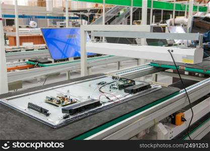 closeup line conveyor assembly televisions in a workshop. line conveyor assembly televisions