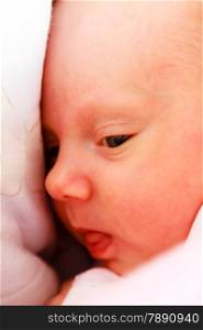 Closeup little newborn baby girl three weeks lying in diaper with open eyes