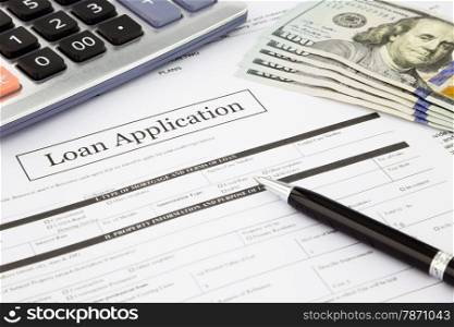 closeup loan application form and dollar banknotes, business and finance concept and idea