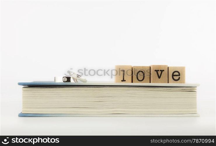 closeup love wording and rings on a book, emotion concept and idea