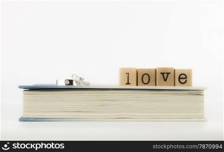 closeup love wording and rings on a book, emotion concept and idea
