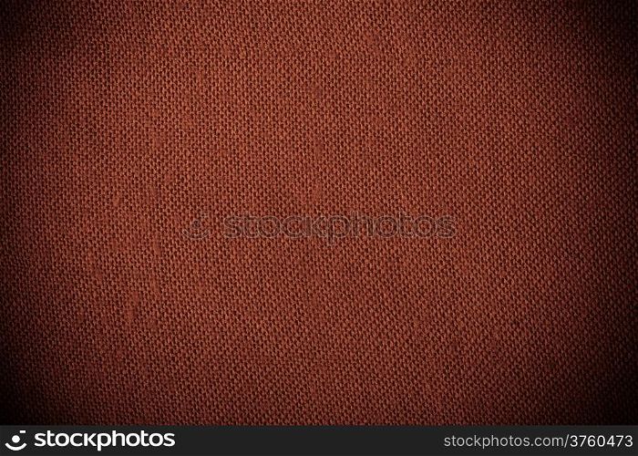 Closeup macro of red brown fabric textile material as texture pattern background or backdrop
