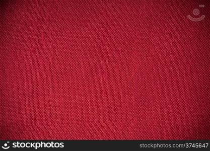 Closeup macro of red fabric textile material as texture pattern background or backdrop