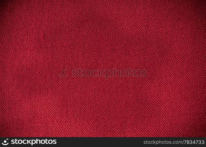 Closeup macro of red fabric textile material as texture pattern background or backdrop