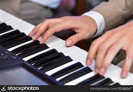Closeup man hand playing piano on wedding or concert