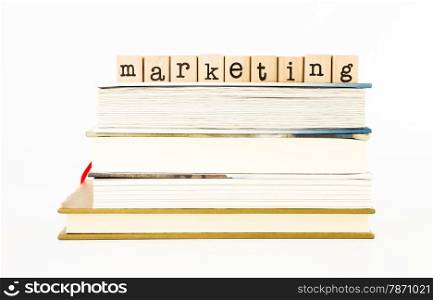 closeup marketing wording stack on books, business and consumerism concept and ideas