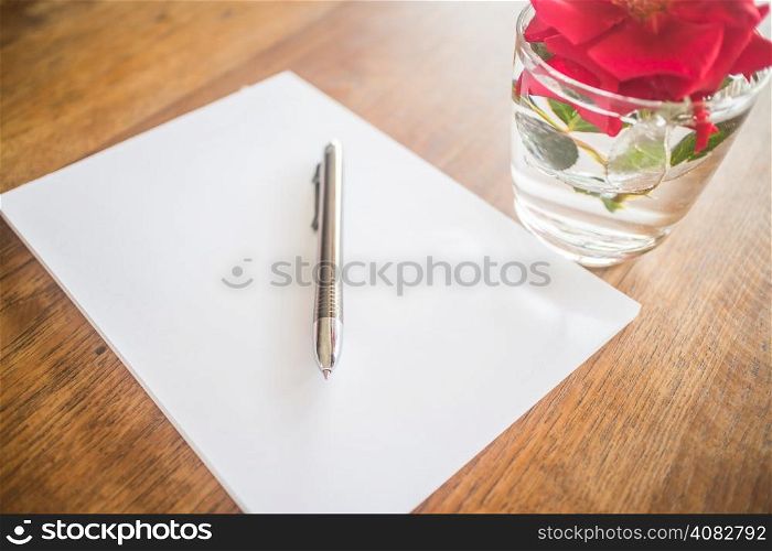 Closeup metal pen on wooden work table, stock photo