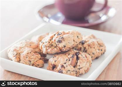 Closeup mixed nut cookies with violet coffee cup, stock photo