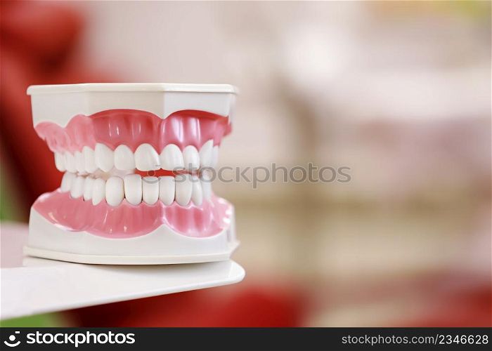 Closeup model of a human jaw with white teeth. jaw in dentistry. copy space. Clean denture, model of the jaw in the dentist&rsquo;s office. Dentistry conceptual photo. Prosthetic dentistry. False teet.. Closeup model of a human jaw with white teeth. jaw in dentistry. copy space. Clean denture, model of the jaw in the dentist&rsquo;s office. Dentistry conceptual photo. Prosthetic dentistry. False teet