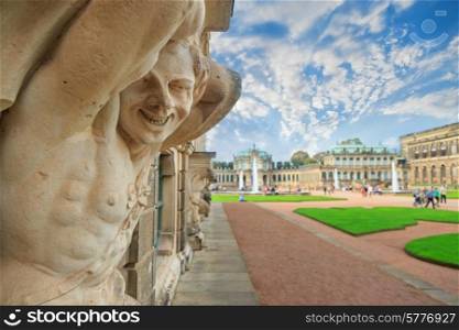 Closeup naked faunus smiling statue crop with fountain and garden at Zwinger palace in Dresden, Germany&#xA;