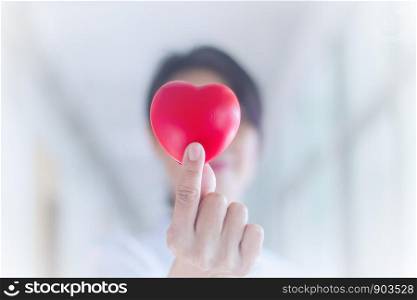 Closeup Nurse hands holding and giving red heart in hospital.healthy and healthcare concept with selective focus.