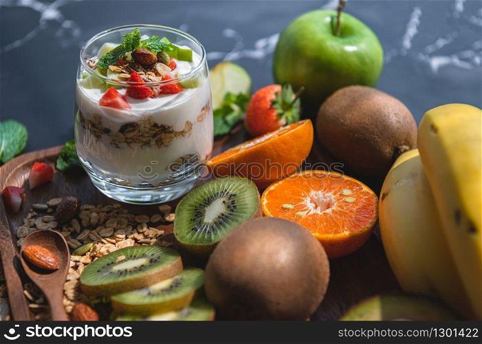 Closeup nutrition yogurt with many fruits on table. Food cuisine and drinks concept. Organic dessert theme.