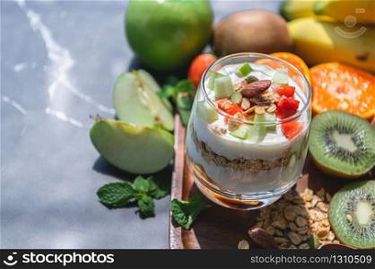 Closeup nutrition yogurt with many fruits on table. Food cuisine and drinks concept. Organic dessert theme.