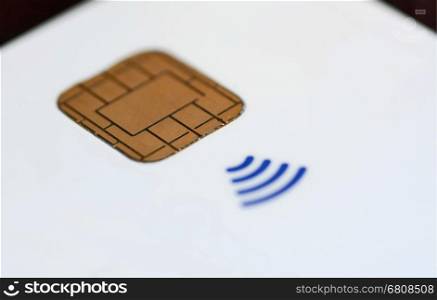 Closeup of a all white contactless credit card without all marks and signs.