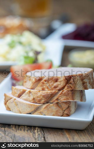 closeup of a bavarian leberkaese on dark wood