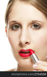 closeup of a beautiful woman applying lipstick. closeup of a beautiful woman applying lipstick on white background