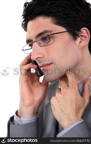 Closeup of a bespectacled businessman on the phone