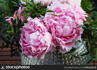 Closeup of a bouquet pink peony summer flowers in a vase. Bouquet of pink peony flowers