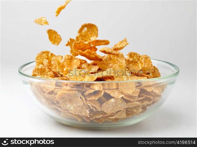 closeup of a bowl with pouring cereal flakes