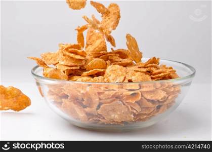 closeup of a bowl with pouring cereal flakes