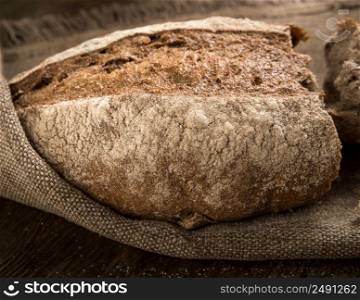closeup of a broken loaf of bread on a cloth napkin. loaf of bread top view