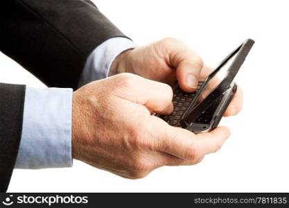 Closeup of a businessman&rsquo;s hands, using his smart phone to text. Shallow depth of field with focus on the hand and part of the keyboard closest to the camera.