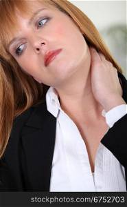 Closeup of a businesswoman with neckache
