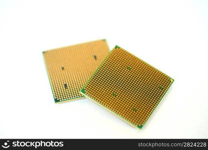 Closeup of a computer processor with golden pins over a white background