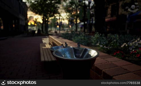 closeup of a drinking water fountain in a park on sunset