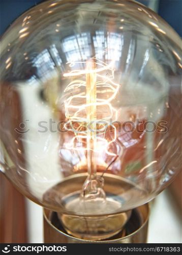 Closeup of a lit light bulb, isolated