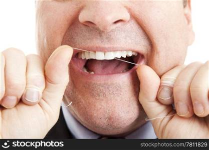 Closeup of a man flossing his teeth with dental floss.