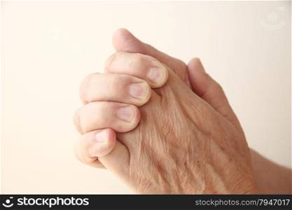 closeup of a man grasping his hand in pain