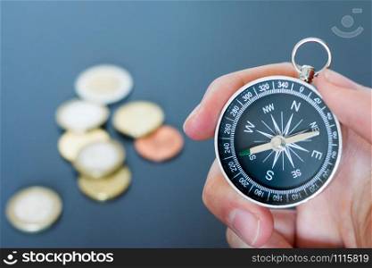Closeup of a mans hand holding a compass in his hand. Concept for business, innovation