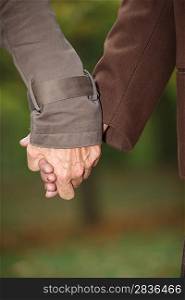 Closeup of a mature couple holding hands